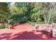 The red stained deck has a wood bench and green trees in the background, creating a relaxing outdoor space at 7300 Chattahoochee Bluff Dr, Atlanta, GA 30350