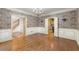 Elegant dining room features classic wallpaper, decorative trim, and gleaming hardwood floors for formal gatherings at 7300 Chattahoochee Bluff Dr, Atlanta, GA 30350