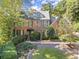 Charming two-story brick home featuring mature landscaping, traditional shutters, and a classic architectural style at 7300 Chattahoochee Bluff Dr, Atlanta, GA 30350