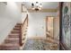 Spacious foyer features a staircase, elegant chandelier, and distinctive flooring creating an inviting entrance at 7300 Chattahoochee Bluff Dr, Atlanta, GA 30350