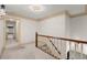 Hallway with wood trim, neutral decor, and a view down the staircase at 7300 Chattahoochee Bluff Dr, Atlanta, GA 30350