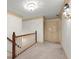 Upstairs hallway with neutral decor, wood trim, and access to bedroom areas at 7300 Chattahoochee Bluff Dr, Atlanta, GA 30350