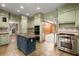 View of the updated kitchen with custom cabinets, island, and stainless steel appliances at 7300 Chattahoochee Bluff Dr, Atlanta, GA 30350