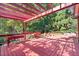 Enjoy outdoor living on the expansive red deck, complete with pergola and ample room for entertaining at 7300 Chattahoochee Bluff Dr, Atlanta, GA 30350