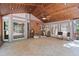 Large, enclosed sunroom with tile floors, wood ceilings, and access to the outside deck at 7300 Chattahoochee Bluff Dr, Atlanta, GA 30350
