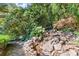 The rock waterfall feature with lush surrounding greenery, add a touch of nature to your private retreat at 7300 Chattahoochee Bluff Dr, Atlanta, GA 30350
