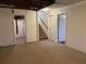 Open basement space with carpet, staircase, and neutral paint, ready for customization at 2787 Heritage Ln, Morrow, GA 30260