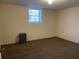 Carpeted basement featuring a single hung window and dehumidifier at 2787 Heritage Ln, Morrow, GA 30260