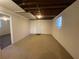 Unfinished basement space with carpet flooring, painted walls, and utility door at 2787 Heritage Ln, Morrow, GA 30260