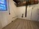 Unfinished basement space with wood-look flooring, painted walls, and utility access at 2787 Heritage Ln, Morrow, GA 30260