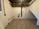 Unfinished basement with concrete walls, overhead piping, and vinyl flooring, awaiting transformation at 2787 Heritage Ln, Morrow, GA 30260