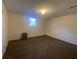 Carpeted basement space featuring a single hung window and dehumidifier unit at 2787 Heritage Ln, Morrow, GA 30260