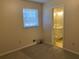 Bedroom featuring a window, neutral carpet flooring, and an ensuite bathroom at 2787 Heritage Ln, Morrow, GA 30260