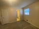 View of the bedroom including ensuite bathroom, window, and neutral carpet at 2787 Heritage Ln, Morrow, GA 30260
