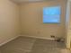 Bedroom with neutral walls, window, and carpet flooring at 2787 Heritage Ln, Morrow, GA 30260