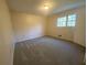 Spacious bedroom features neutral carpet, a window with natural light, and neutral walls at 2787 Heritage Ln, Morrow, GA 30260