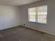 Cozy bedroom has large window that offers bright light and neutral carpeting and wall color at 2787 Heritage Ln, Morrow, GA 30260