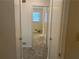 View of the bedroom from the hallway, featuring neutral walls and carpet flooring at 2787 Heritage Ln, Morrow, GA 30260