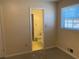 Neutral bedroom featuring a window with natural light and an ensuite bathroom at 2787 Heritage Ln, Morrow, GA 30260