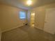 Bedroom with window, neutral carpet flooring, and ensuite bathroom at 2787 Heritage Ln, Morrow, GA 30260