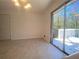Bright dining area features modern light fixture, tile floor, and sliding glass doors to the outdoor deck at 2787 Heritage Ln, Morrow, GA 30260