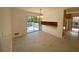 Bright dining area features modern light fixture, tile floor, and sliding glass doors to the outdoor deck at 2787 Heritage Ln, Morrow, GA 30260