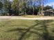 View of the front yard of the property with circular drive, grass, and trees at 2787 Heritage Ln, Morrow, GA 30260