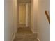 Neutral hallway and trim leads to a bedroom with neutral walls and carpeting at 2787 Heritage Ln, Morrow, GA 30260