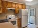 Well-lit kitchen with appliances and ample counter space and an exterior door at 2787 Heritage Ln, Morrow, GA 30260