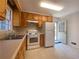 Bright kitchen with wooden cabinets, standard appliances, and an outdoor window at 2787 Heritage Ln, Morrow, GA 30260