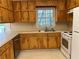 Functional kitchen with wooden cabinets, stainless steel dishwasher, and tiled floor at 2787 Heritage Ln, Morrow, GA 30260