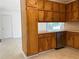 Functional kitchen with wooden cabinets, stainless steel dishwasher, and tiled floor at 2787 Heritage Ln, Morrow, GA 30260