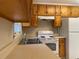 Bright kitchen with wooden cabinets, standard appliances, and an outdoor window at 2787 Heritage Ln, Morrow, GA 30260