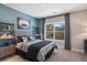 Stylish bedroom featuring a comfortable bed, accent wall, and ample natural light at 729 Keystone Dr, Woodstock, GA 30188