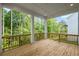 Enjoy scenic views from this wooden deck surrounded by lush greenery and tall trees at 729 Keystone Dr, Woodstock, GA 30188