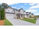 Charming two-story home with a gray facade, covered porch, and well-manicured lawn in a new neighborhood at 729 Keystone Dr, Woodstock, GA 30188