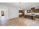 Spacious open-concept kitchen and dining area featuring hardwood floors, a kitchen island, and a dining area at 729 Keystone Dr, Woodstock, GA 30188