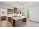 Stylish kitchen features a large island with quartz countertop, stainless steel appliances, and hardwood floors at 729 Keystone Dr, Woodstock, GA 30188