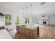Bright kitchen with a large island, modern appliances, and open view to the living room with a fireplace at 729 Keystone Dr, Woodstock, GA 30188