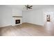 Bright living room with hardwood floors, a fireplace, and a ceiling fan at 729 Keystone Dr, Woodstock, GA 30188