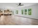 Open-concept living space featuring hardwood floors, modern lighting, and a seamless flow to the kitchen at 729 Keystone Dr, Woodstock, GA 30188