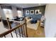 Bright living room featuring a modern accent wall, stylish furniture, and hardwood floors at 729 Keystone Dr, Woodstock, GA 30188