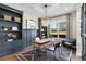 Stylish home office with custom built-ins, modern chandelier, and a large window at 729 Keystone Dr, Woodstock, GA 30188