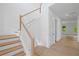 Elegant staircase with wooden treads and white risers, complemented by a light wood handrail and white walls at 729 Keystone Dr, Woodstock, GA 30188