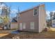 The backyard has a concrete patio, a lush green lawn, and a view of the home's light brown siding at 6427 Grey Fox Way, Riverdale, GA 30296