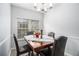 Cozy dining room with wooden table, seating for four, and a large window at 6427 Grey Fox Way, Riverdale, GA 30296