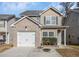 Charming two-story home with brick accents, a one-car garage, and well-maintained landscaping at 6427 Grey Fox Way, Riverdale, GA 30296