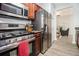 Well-equipped kitchen with stainless steel appliances, gas range, and wood cabinetry at 6427 Grey Fox Way, Riverdale, GA 30296