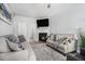 Comfortable living room featuring a fireplace, neutral decor, and plenty of seating at 6427 Grey Fox Way, Riverdale, GA 30296