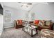 Cozy living room featuring vaulted ceilings, neutral paint, plush carpet, and multiple windows providing lots of natural light at 6427 Grey Fox Way, Riverdale, GA 30296